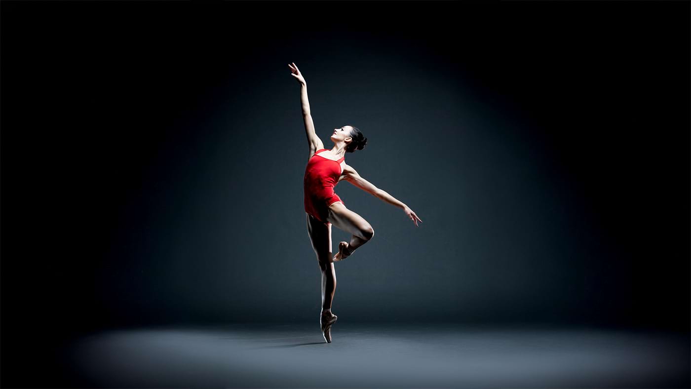 Buse Babadag in red leotard under spotlight — studio portrait