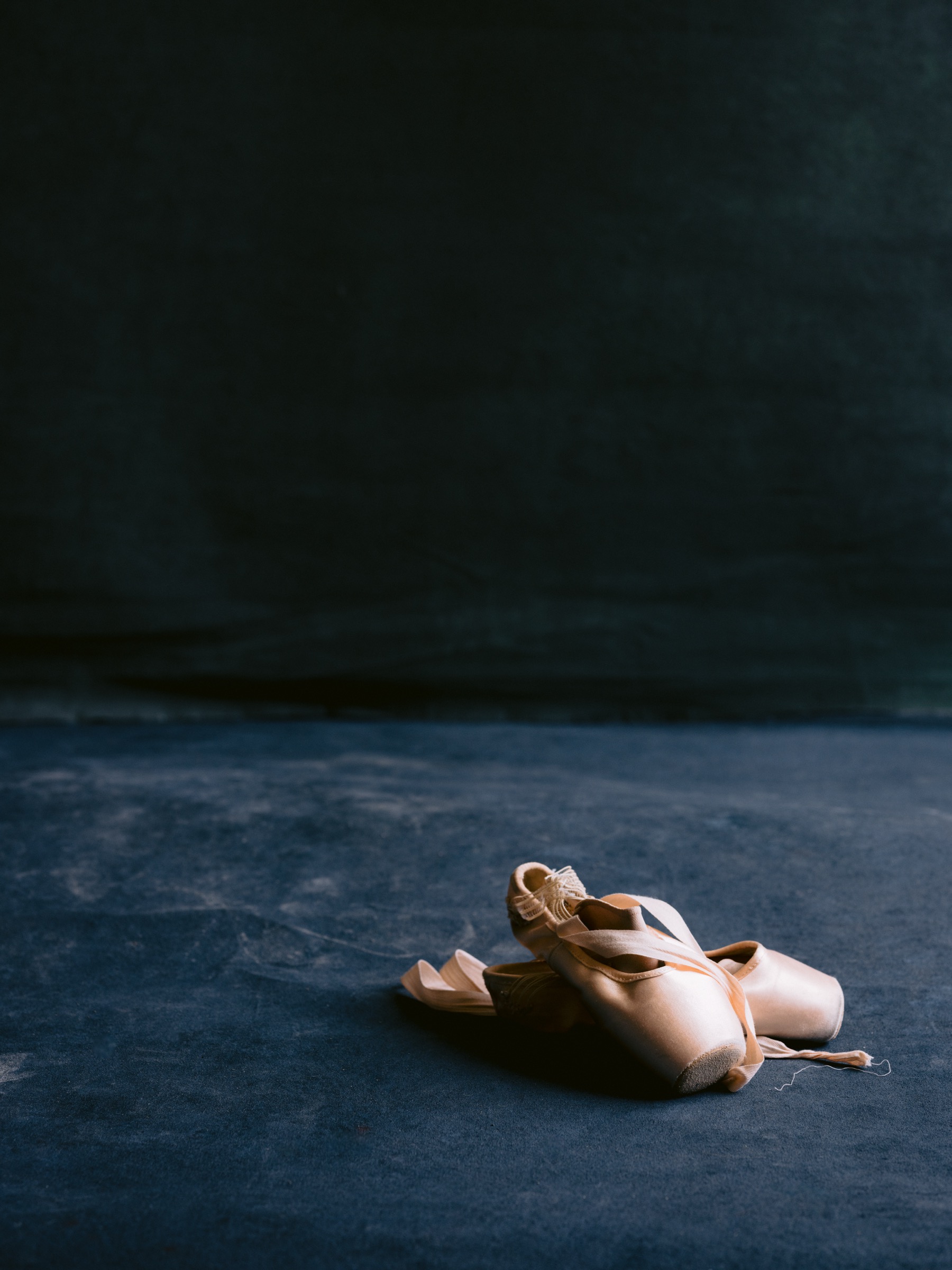 Ballet pointe shoes resting on studio floor